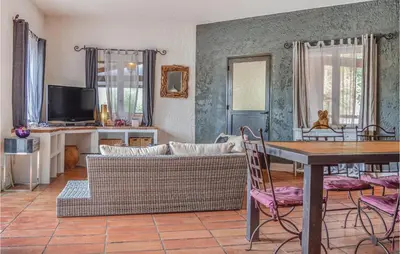 a living room with a couch and a table at Gorgeous Home In Figari in Figari
