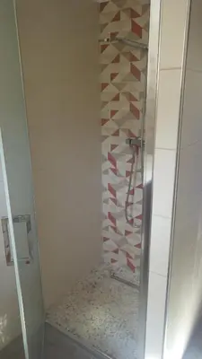 a shower with a glass door in a bathroom at RESIDENCE U RE D' ALZETTU in Porto-Vecchio