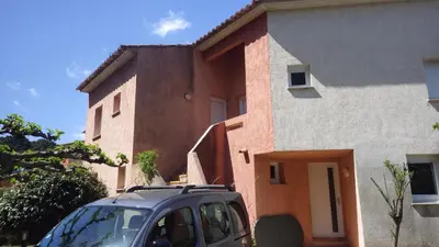 a car parked in front of a house at RESIDENCE U RE D' ALZETTU in Porto-Vecchio