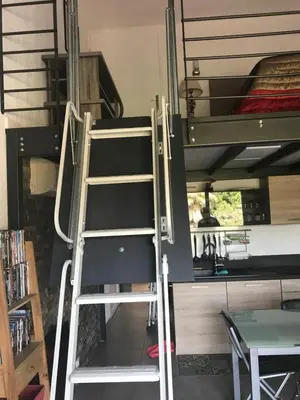 a ladder leaning against a bunk bed in a room at RESIDENCE U RE D' ALZETTU in Porto-Vecchio