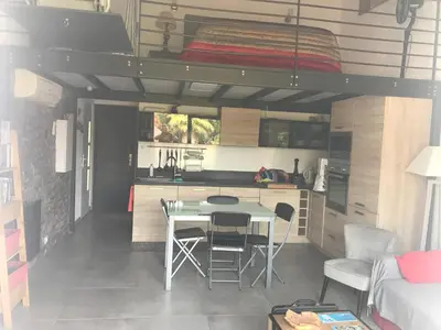 a small kitchen with a table in a tiny house at RESIDENCE U RE D' ALZETTU in Porto-Vecchio