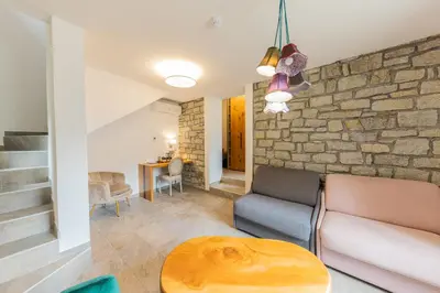 a living room with a couch and a table at Hôtel de la Restonica in Corte