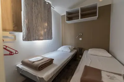 a hospital room with two beds and a sink at Camping Corsica Paradise in Calcatoggio