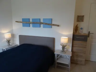 a bedroom with a bed and two tables with lamps at Villa 8 au Village Marin in Porto-Vecchio