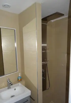a bathroom with a shower and a sink and a mirror at Villa 8 au Village Marin in Porto-Vecchio