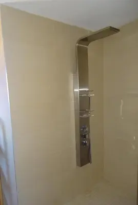 a shower stall in a bathroom with a toilet at Villa 8 au Village Marin in Porto-Vecchio