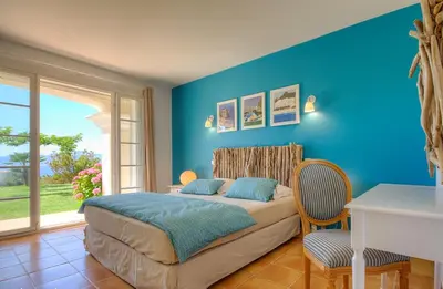 a bedroom with a bed with a blue wall at Casa di Andria in Pietrosella