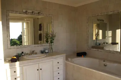 a bathroom with a tub and a sink and a mirror at Casa di Andria in Pietrosella
