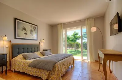 a bedroom with a bed and a large window at Casa di Andria in Pietrosella