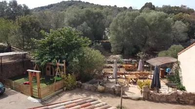 a backyard with a playground with a play yard at Macchie e Fiori in Pianottoli-Caldarello