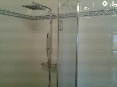 a shower with a glass door in a bathroom at A Mandria in Porticcio