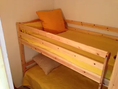 a bunk bed with an orange pillow on top of it at Les Marines de Morian in Moriani Plage