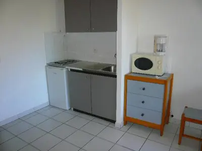 a kitchen with a sink and a microwave on a table at Les Marines de Morian in Moriani Plage