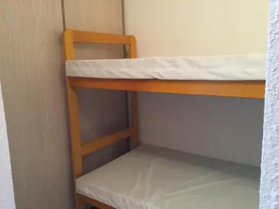 a bunk bed with a ladder on the bottom bunk at Les Marines de Morian in Moriani Plage