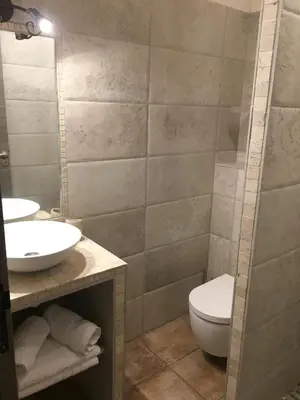 a bathroom with a sink and a toilet and a mirror at Maredda 1 in Sartène