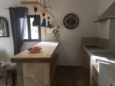 a kitchen with a bowl of fruit on a counter at Maredda 1 in Sartène