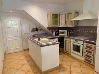 a kitchen with a sink and a counter top at Villa Pampasgiolu in Tizzano