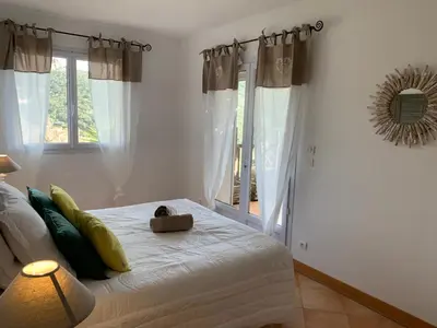 a bedroom with a bed and a window at Villa Pampasgiolu in Tizzano