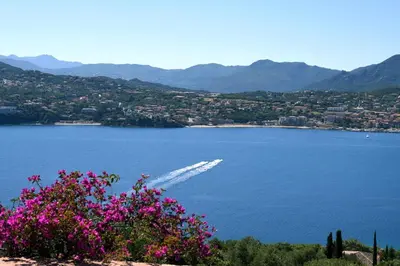 a view of a lake with a boat in the water at Villa Vetricella Corse Sud in Olmeto