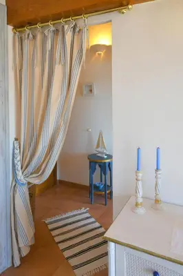 a living room with a curtain and a table at Villa Vetricella Corse Sud in Olmeto