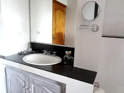 a bathroom with a sink and a mirror at Villa Vetricella Corse Sud in Olmeto