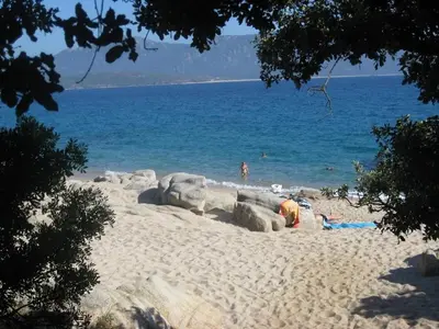 a group of people on a beach near the water at Villa Vetricella Corse Sud in Olmeto