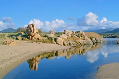 a body of water with rocks in the middle at Villa Vetricella Corse Sud in Olmeto
