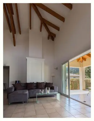 a living room with a couch and a glass table at Villa 4 étoiles Sole di Corsica in Cauro