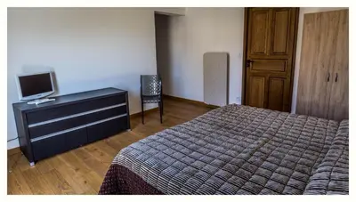a bedroom with a bed and a dresser with a television at Villa 4 étoiles Sole di Corsica in Cauro
