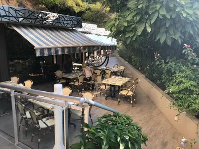an outdoor patio with tables and chairs and plants at Castel Vecchio in Ajaccio