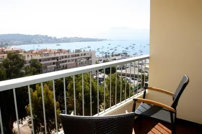 a balcony with two chairs and a view of the water at Castel Vecchio in Ajaccio