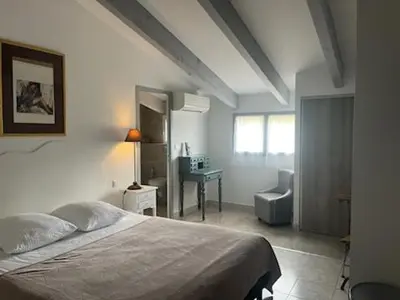 a bedroom with a bed and a chair and a desk at Auberge du col saint Georges in Grosseto-Prugna