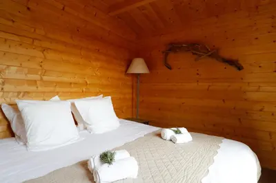 a bedroom with a bed in a log cabin at Auberge U Sirenu in Sartène