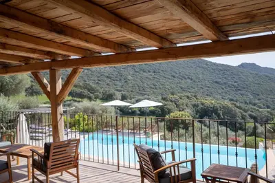a patio with a view of a swimming pool at Auberge U Sirenu in Sartène