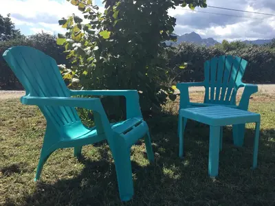 two blue chairs sitting next to each other in the grass at Villa E Lecce in Santa-Lucia-di-Moriani