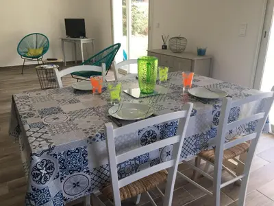 a dining room table with a blue and white table cloth at Villa E Lecce in Santa-Lucia-di-Moriani