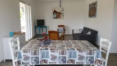 a living room with a table with a blanket on it at Villa E Lecce in Santa-Lucia-di-Moriani