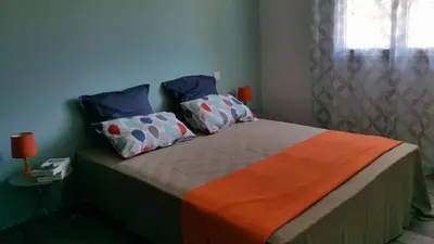 a bedroom with a bed with two pillows on it at Villa E Lecce in Santa-Lucia-di-Moriani