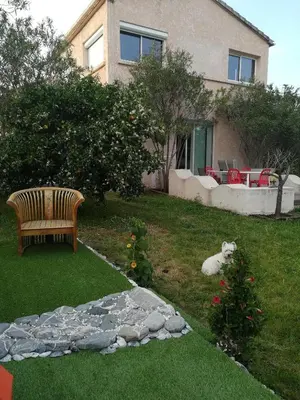 a backyard with a fence and a driveway at Villa de charme avec piscine in Ghisonaccia
