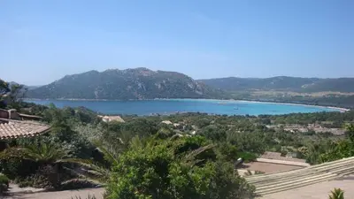 a view of a lake with mountains in the background at Mini-villa Vista bella in Porto-Vecchio