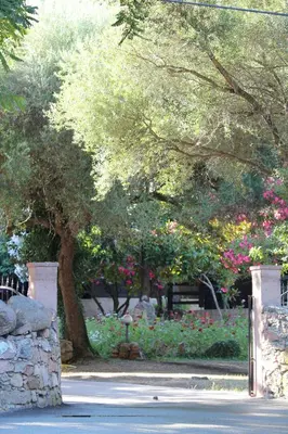 a park with a bunch of flowers and trees at Résidence Marina Livia in Serriera