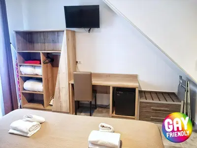 a small room with a desk and a tv at L'Escale in Bonifacio