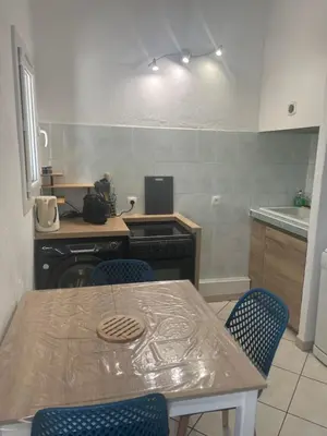a kitchen with a table and chairs and a stove at Residence 