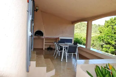 a patio with a table and chairs on a balcony at Residence 