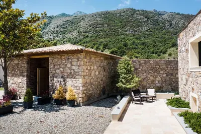 a balcony with two white chairs and a tree at Kyrn Flor - Domaine Sant Antone in Corte
