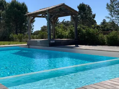 a swimming pool with a gazebo in a yard at Cala Rossa Appart in Porto-Vecchio