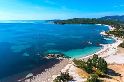 an aerial view of a beach and the ocean at Cala Rossa Appart in Porto-Vecchio