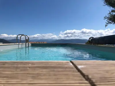a swimming pool with a view of the mountains at Les Villas MarInCelu in Porto Pollo