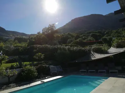 a swimming pool with a view of a mountain at A Sulana Chambre d'hôtes in Valle-di-Campoloro