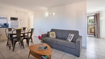 a living room with a couch and a table at locations calenzana in Calenzana